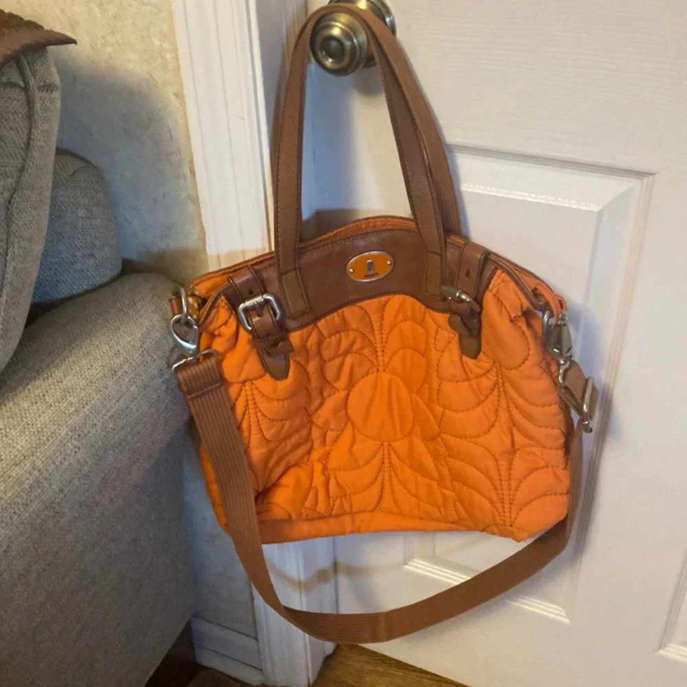 Fossil nylon orange bag with strap.